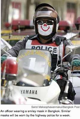 To lift motorists, smiley masks for Thai police - International Herald Tribune_1231781747072
